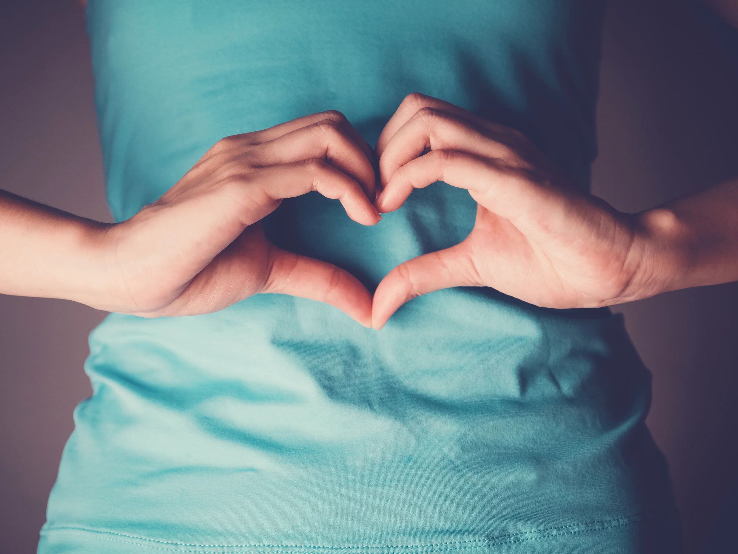 Woman Holding Her Hands Up in shape of Heart